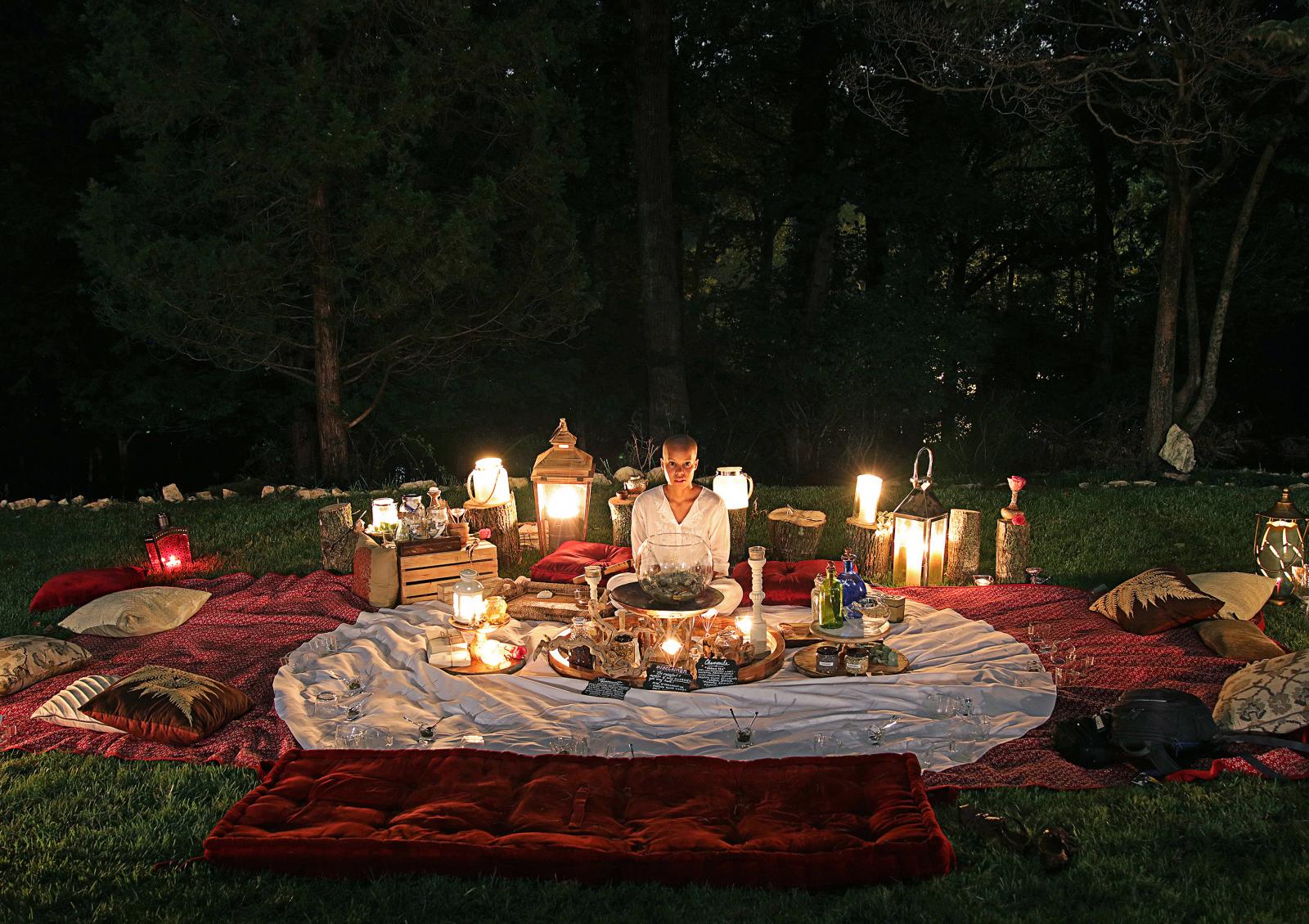 Based on the research & work of Dr. Masaru Emoto; I facilitate a silent tea ceremony in which we create a communal brew in one central cauldron. This silent, sunset tea ceremony explores water as the carrier of messages and the potential for healing through immersive communal ceremony. Herbalism (plant medicine) and hand embroidery (canvas tea bags embroidered with affirmations by myself and my Grandmother) link this ceremony to ancestral wisdom traditions. The use of herbs/roots and sewing messages into fabric invokes African American quilting traditions (my Great Grandmother) and ancient herbalism practices.
This photograph was taken directly following the ceremony which had 40 participants.