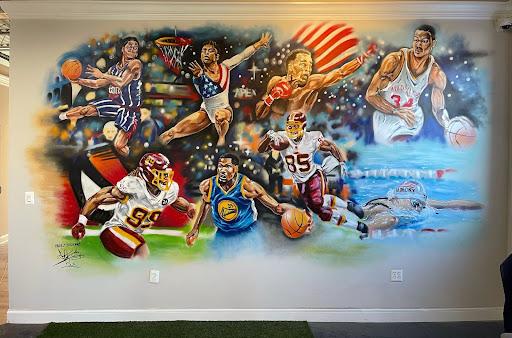 Date: 1/9/2021
Title: DMV Legends
Size: 13ft x 18ft
Address: Apex Performance Therapy 14672 Southlawn Ln Suite G, Rockville, MD 20850
Commission by: Apex Performance Therapy
Cost: $12k
Description: This mural was commissioned for Apex Performance Therapy, located in Rockville, MD, a business dedicated to optimizing performance training and aiding in physical therapy recovery. Situated in the heart of the DMV (District of Columbia, Maryland, Virginia), Apex Performance Therapy strives to help individuals achieve their full potential. The artwork itself pays homage to notable athletes hailing from the DMV region, including Katie Ledecky, Kevin Durant, Steve Francis, Len Bias, Sugar Ray Leonard, and many others.