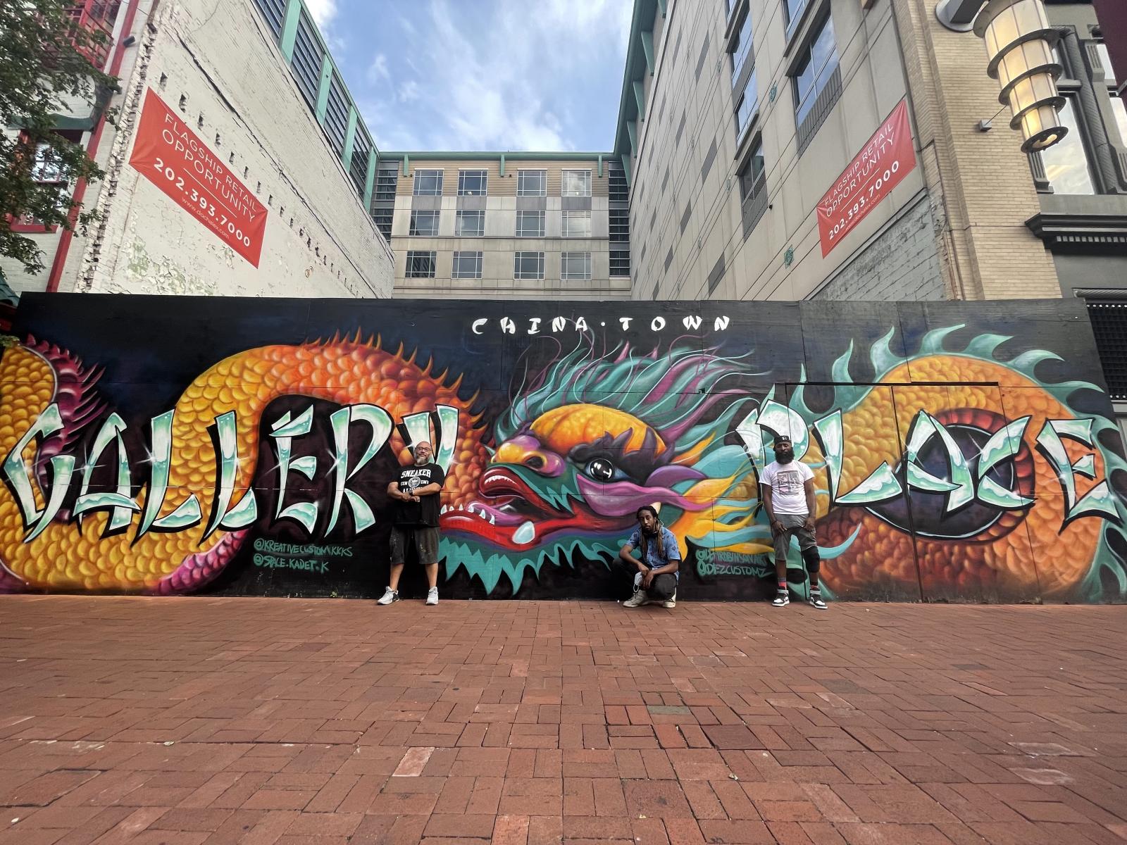 Date: 6/27/2021
Title: Dragon Guarding the Gates
Size: 12x40ft
Address: gallery place (Chinatown, DC) 630 H St NW, Washington, DC 20001
Commission by: OXFORD PROPERTIES
Cost: 22k
The mural titled "Dragon Guarding the Gates" serves as a heartfelt tribute to the rich cultural heritage of Chinatown, DC. Collaborating with Oxford Properties on multiple projects, the lead artist, Levi Robinson, along with myself, were entrusted with the task of creating a mural that would honor the vibrant culture of this unique area in Washington, DC. The talented assistant artists, Mohammed Gafar and Mckay Ifaedi, played integral roles in bringing this vision to life. Using spray paint as our medium, we skillfully executed this awe-inspiring mural. The artwork stands as a testament to the collective effort and dedication poured into capturing the essence of Chinatown, DC, and its significance within the larger cultural landscape of the city.