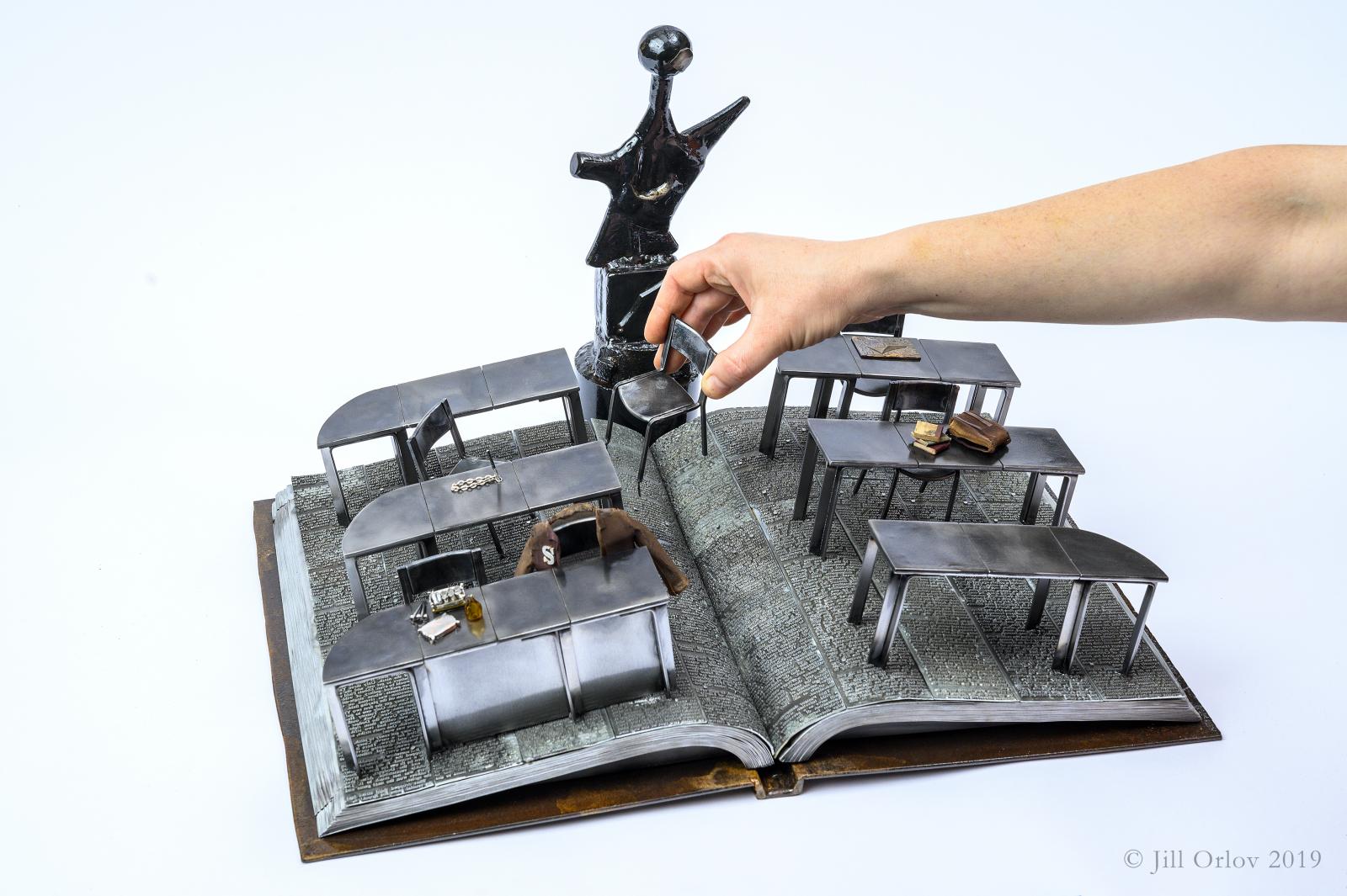 Based on the classic movie The Breakfast Club - a miniature vignette of the library scene set within a full scale book made of steel and other metals. All TIG welded construction.