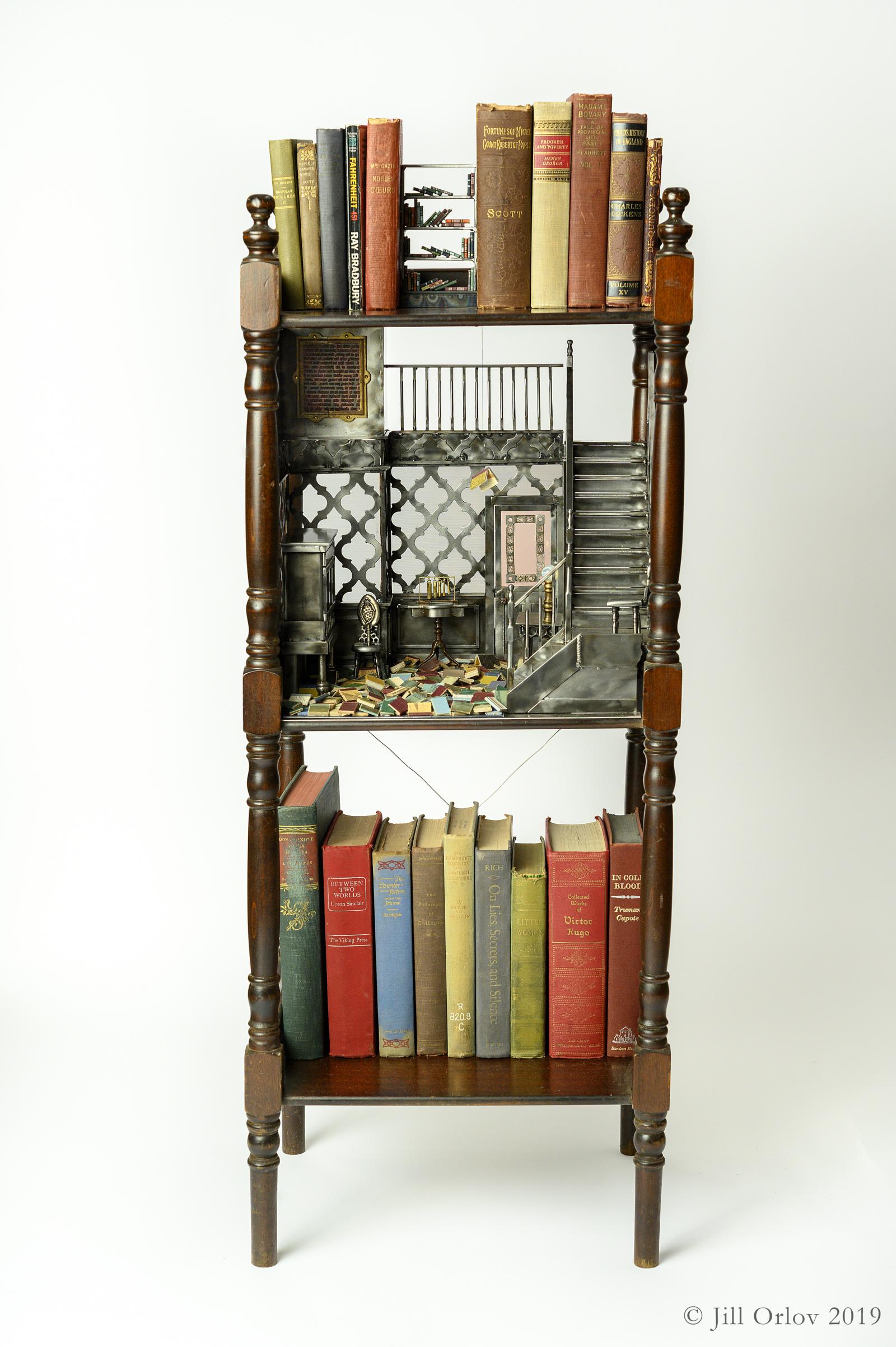 Full view of miniature vignette based on the book Fahrenheit 451 - set within the middle section of a Victorian bookshelf with the miniature attic above embedded in the full scale books