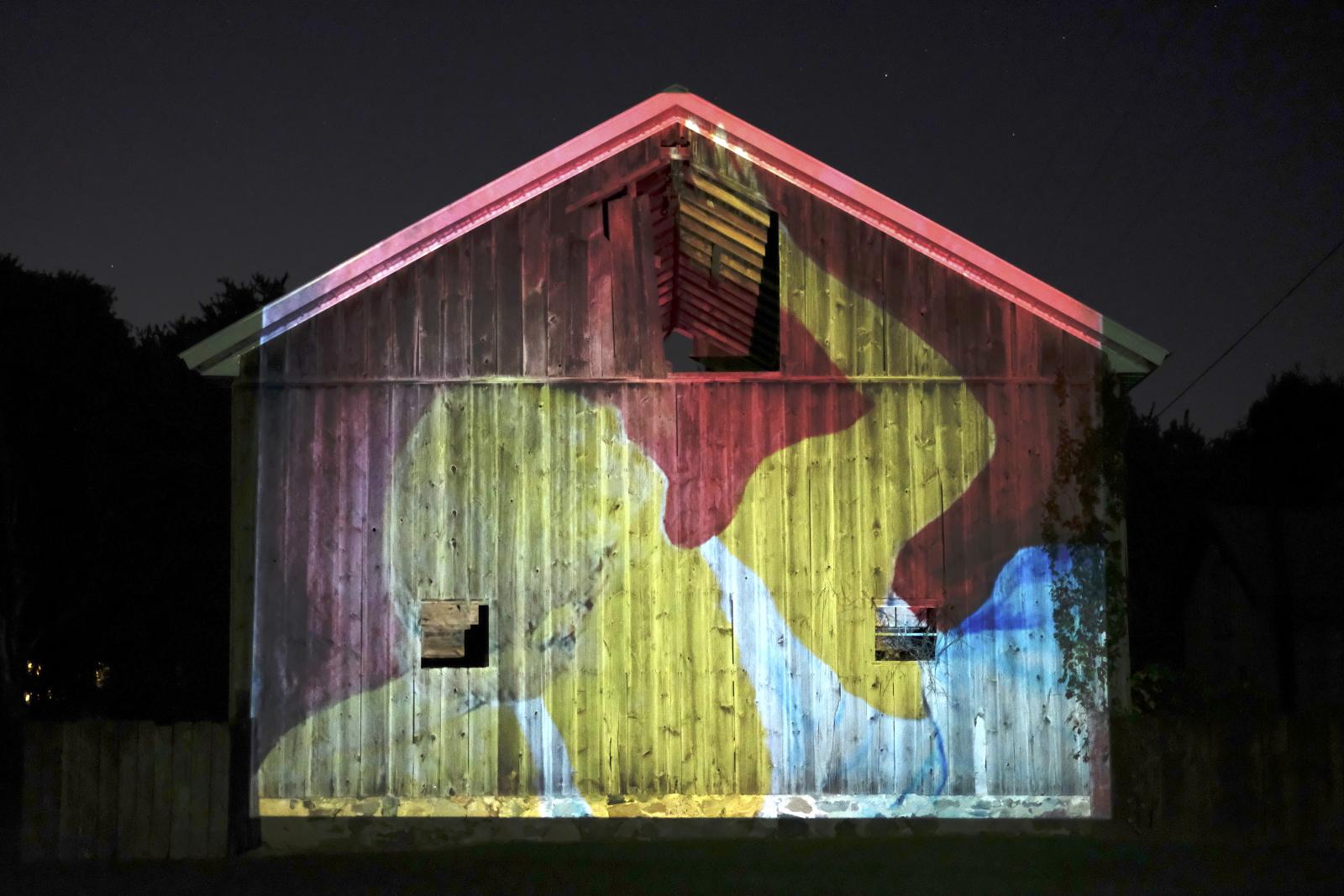 Night Projection of Self-portrait (painting) on Family Barn