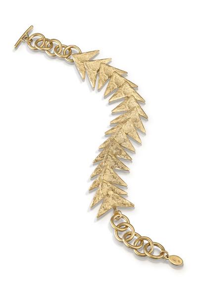 This striking bracelet features a trailing row of arrows. Each arrow is delicately textured to mimic the surface of rocks. Bracelet includes a toggle clasp.