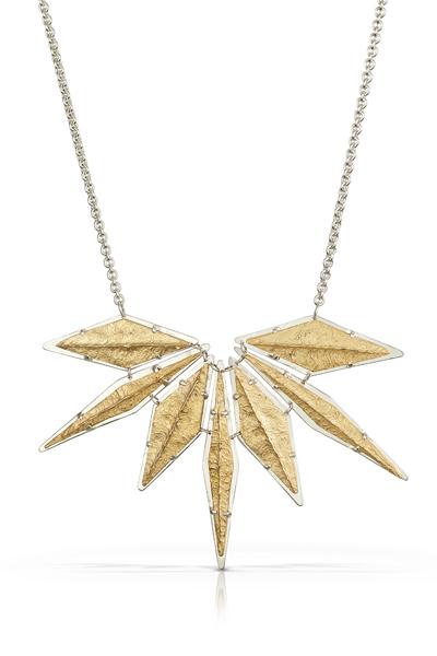 This two-tone necklace makes quite the statement! Necklace features eight prong set pieces, each delicately textured to mimic a rocky ridge.