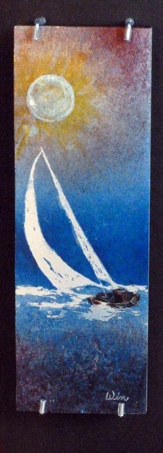Sailing is my interpretation of a sailboat gliding through the water with the sun shining brightly.  The work is on aluminum with a black metal frame.