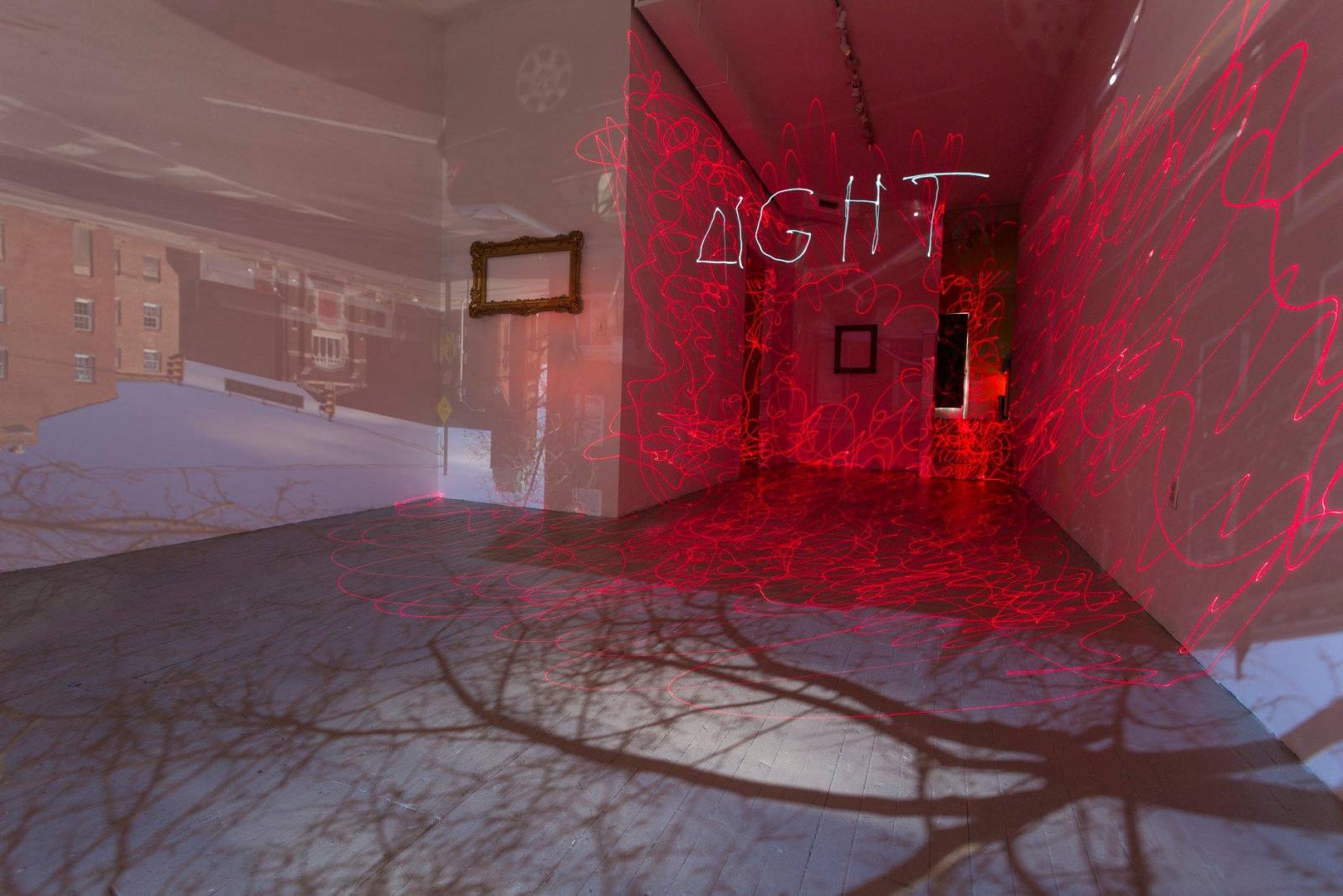 This photograph is a 6 minute exposure inside a room size camera obscura. While the outside street scene is projecting into the space, two photographers animated the otherwise dim room with clip lights and laser pointers. The word, "photography" is built from two Greek words: "photo" for light and "graphe" for drawing, thus, "drawing with light."