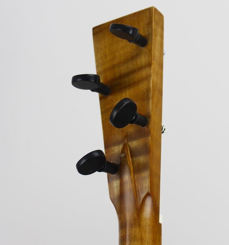 Neck cut from raw maple, stained, finished and fit to gourd. Gourd cut open, cleaned out and prepared for goat-skin soundboard. Goatskin soaked and stretched over opening in gourd. Strings stretched from handmade tailpiece, over hand made bridge and nut, then to tuning pegs.