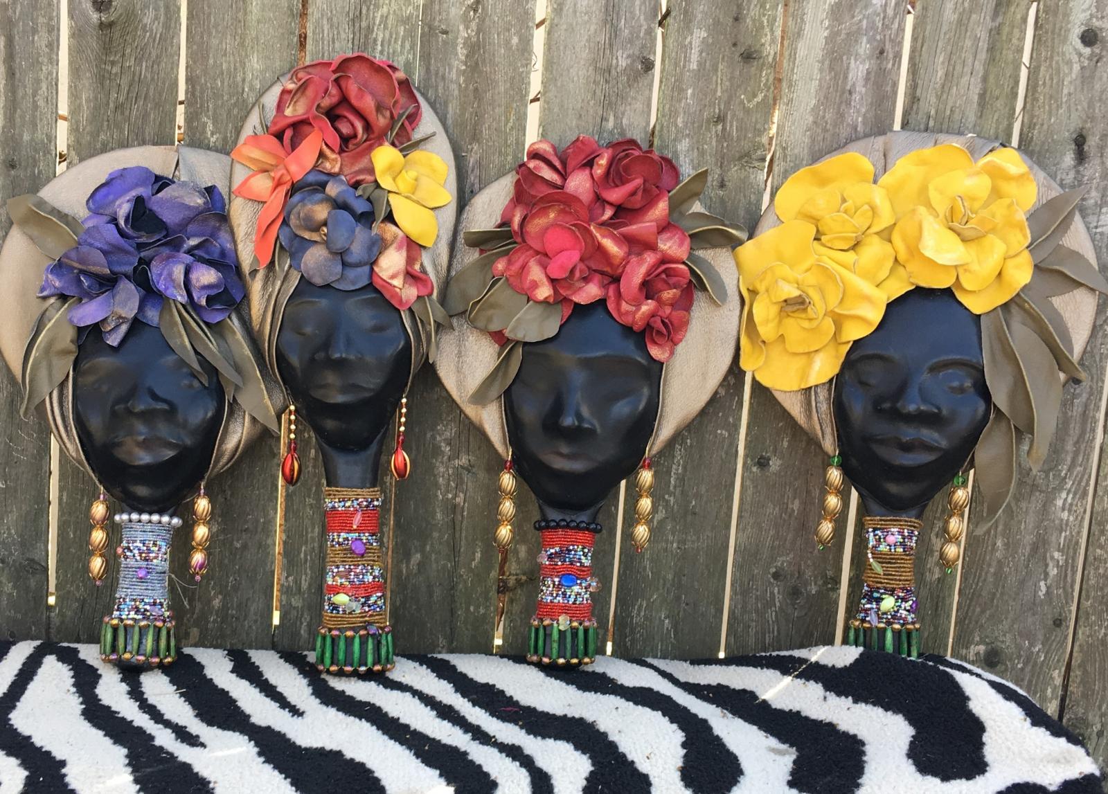 Molded leather faces adorned with flowers and beads