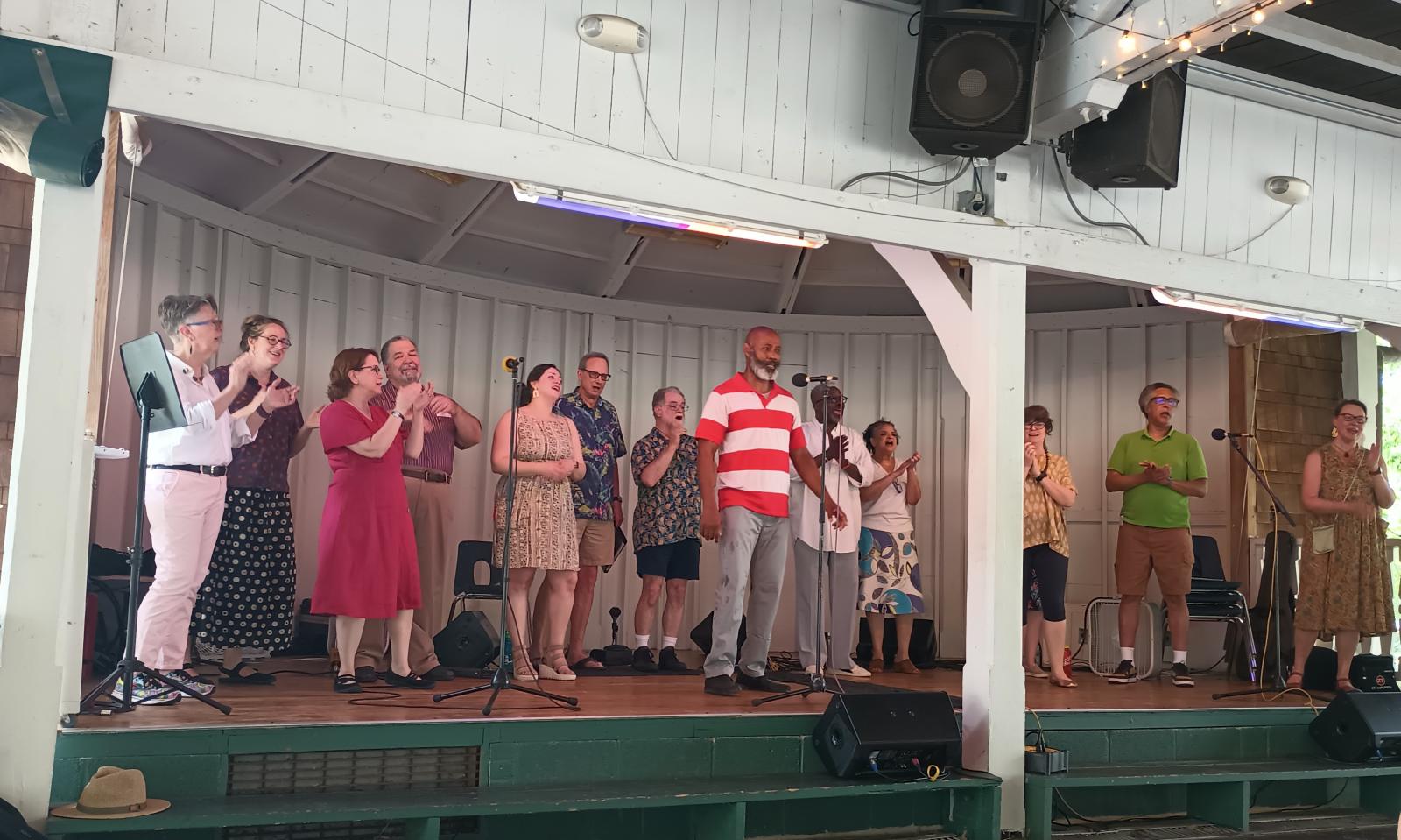 Members of Washington Revels Heritage Voices perform on the stage of the Glen Echo Bumper Car Pavilion in June of 2024.