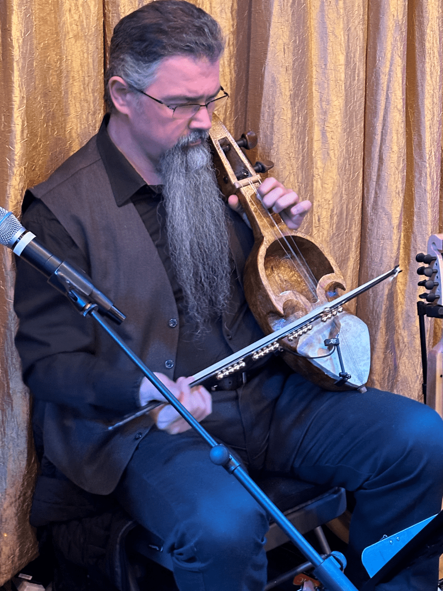 When some friends who knew that Spyro has a passion for traditional instruments gifted him a Nepali Sharangi, he immediately fell in love with the instrument. Not only does the drone string in the middle course sound like a Greek island bagpipe, but the instrument also has commonality with the origins of the bouzouki and rebetiko music - in its historic association with the poor and lower cast of people - an instrument of people going through hard times. Similar to the Greek Lyras and with a strong and throaty/crying sound, the Sharangi became one of the instruments Spyro has come to respect. Here, he is playing a Christmas Carol (Kalanta) from the region of Ikaria at the 2023 Creative Cauldron Holiday Cabaret.