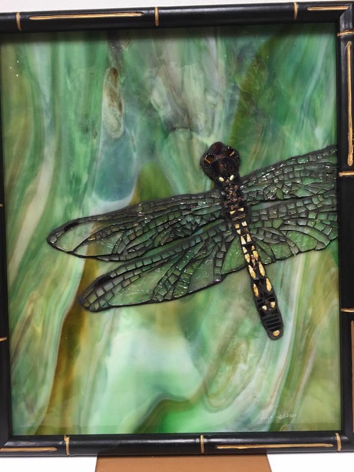Glass on glass mosaic using Iridiscent glass, beads, and stained glass on stained glass background. Custom framed in bamboo.