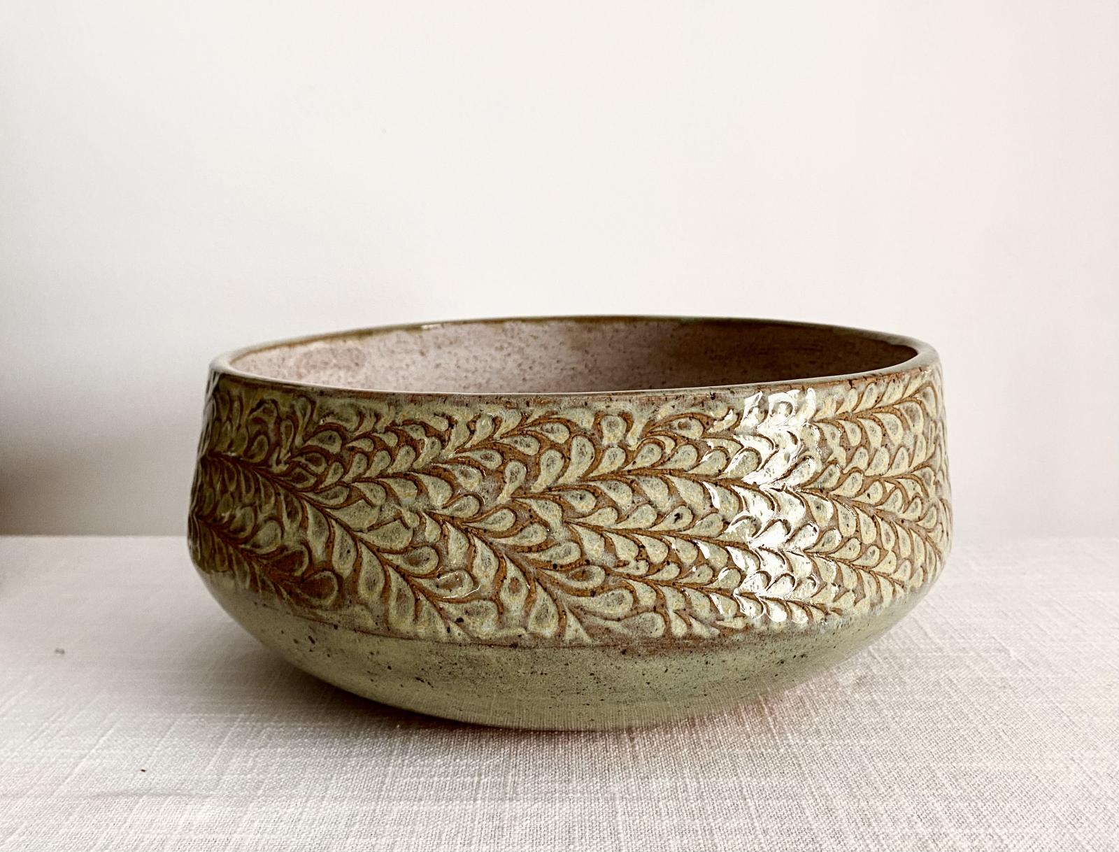 Large stoneware bowl with exterior texture. Fired to 2167 F with food safe glazes. Food and microwave safe.