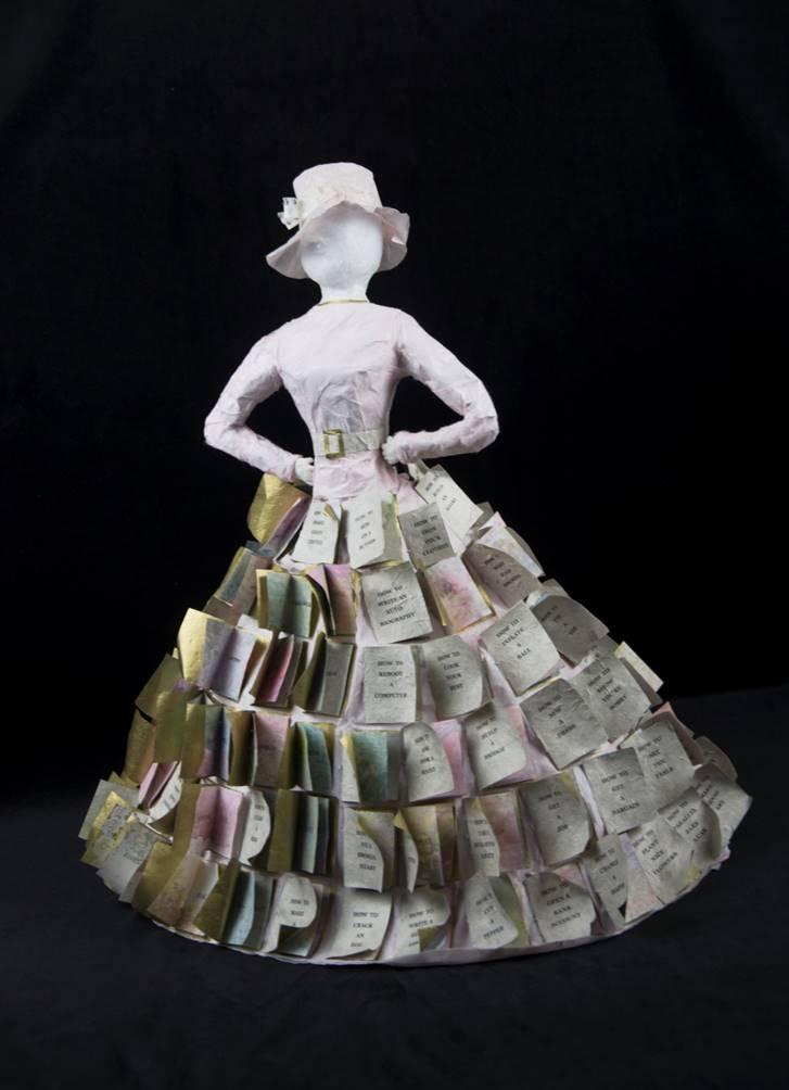 Sculpture of women with monotype printed, hand bound "How To" books with advice inside, sewn on to create a skirt.