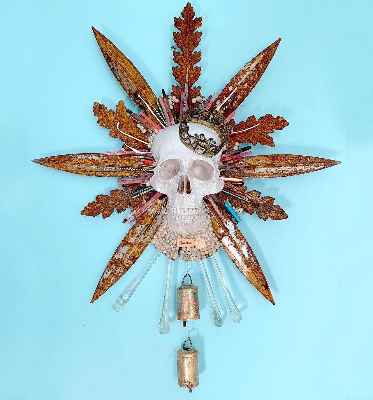 hand-cast plaster skull memento mori with rusted leaves, lampwork glass, sea urchin quills, adorned crown, and brass bells