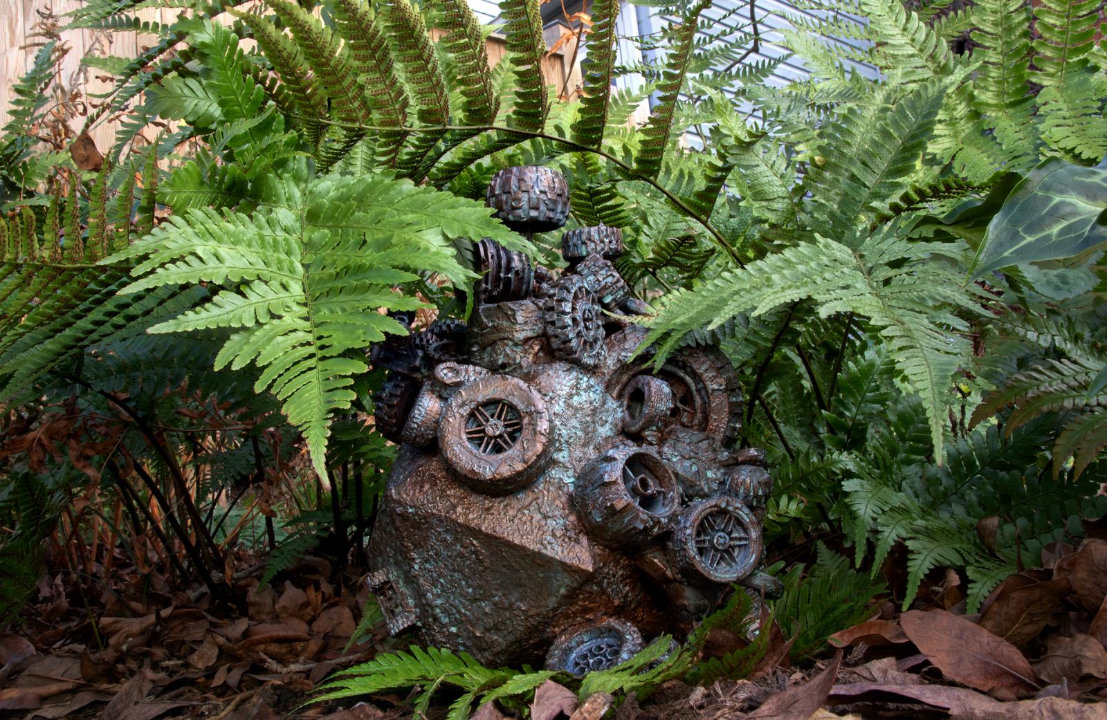 At the heart of this photograph is an icosahedron (or 20-sided polyhedron); the symbol for water in Plato’s cosmology of the universe. This element is situated in a landscape and is clad in detritus such as tires and plastics that commonly pollute and threaten our water.