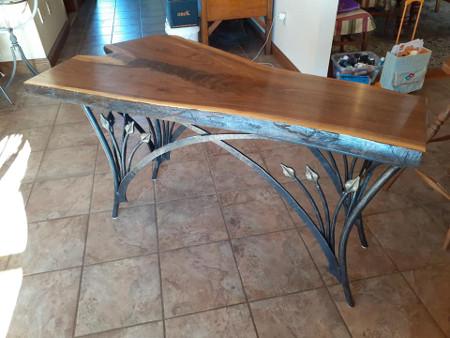 Hot forged steel table base with black walnut top.